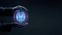 Businessman hands protecting glowing lightbulb with brain inside symbolizing creative ideas, innovation, intellectual property and mind power concept.