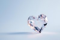 Crystal heart gemstone on soft blue background, sparkling with light reflections for romantic concepts, jewelry design, or luxury gift presentations.