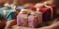 Colorful wrapped gift boxes with golden ribbons on wooden surface for holiday celebrations, birthdays and special occasions.