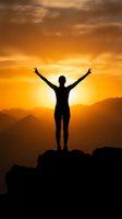 Silhouette of person with raised arms celebrating success on mountain peak during golden sunset with dramatic orange sky and layered mountain ranges.