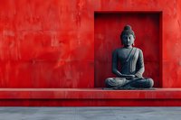 Serene Buddha statue in meditation pose against vibrant red textured wall background, creating dramatic spiritual contrast between modern and traditional elements.