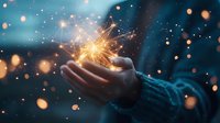 Glowing sparkler in cupped hands against dark blue background with magical bokeh lights, creating dreamy atmospheric holiday celebration moment.