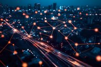 Glowing network connections over blurred city skyline at night with light trails on highway, representing digital transformation and smart city technology.