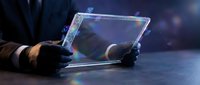 Futuristic holographic tablet with glowing blue interface held by hands wearing black gloves, advanced technology concept for digital innovation and sci-fi design projects.