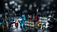 Laboratory glassware with colorful chemical solutions on dark background. Science research equipment for experiments and analysis in modern lab setting.