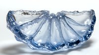 Blue crystal glass bowl with scalloped edges and decorative ridged pattern, elegant tableware for dining and home decor on white background.