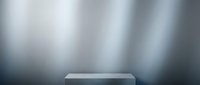 Empty podium platform on blurred metallic background for product display and presentation showcase with soft lighting effects.
