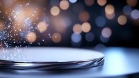 Magical sparkles floating over reflective metallic surface with soft bokeh lights background creating dreamy atmospheric composition. Macro photography.