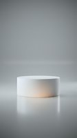 Minimalist white cylindrical podium on a gray background with soft warm glow, for product display, cosmetics, and luxury brand presentations.