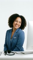 Smiling African American customer service representative woman in blue blazer at desk with headset and computer for business support and assistance.