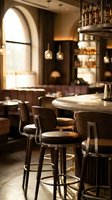 Upscale restaurant interior with wooden bar stools at marble counter, arched window, pendant lights, and well-stocked liquor shelves creating warm ambiance for fine dining and hospitality design.