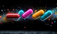 Colorful glowing medical capsules floating in dark space with sparkling powder explosion effect and vibrant particle dispersion on black background.