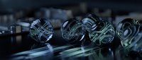 Futuristic glass spheres with glowing circuit board patterns on dark reflective surface, symbolizing technology, AI, and digital innovation.