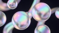 Iridescent glossy spheres with holographic rainbow reflections on dark background, futuristic abstract concept for technology, beauty, or luxury design.