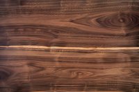 Rich brown walnut wood texture with natural grain pattern and knots, showing detailed woodgrain lines and organic swirls in dark chocolate tones.
