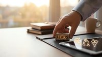 Business professional stamping LEADS on tablet with marketing icons, lead generation concept for sales and digital marketing strategies.