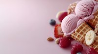 Pink berry ice cream scoops in waffle cones with fresh raspberries, strawberries, blueberries, banana slices and nuts on pink background with copy space.