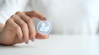 Close-up of hand holding glowing sphere with user profile icon, representing digital identity, networking, and professional connections for business solutions.