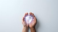 Hands holding glowing shield symbol representing data protection, cybersecurity, and digital safety for web and app design projects.