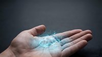 Young adult male hand holding glowing digital holographic brain wireframe on dark background, representing artificial intelligence, technology innovation, and futuristic computing solutions.
