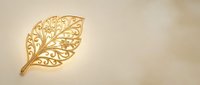 Elegant golden leaf with intricate filigree pattern on cream background, perfect for luxury branding, wedding invitations, and sophisticated design projects.