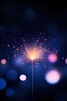 Glowing sparkler emitting bright orange sparks against dark blue bokeh background, creating magical festive atmosphere for celebration and holiday designs.
