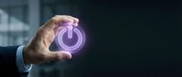 Male hand in business suit holding glowing purple power button icon. Concept for energy management, technology control, startup launch, and digital solutions for corporate applications.