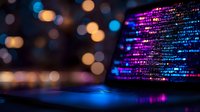 Computer screen displaying colorful programming code with purple and blue hues against dark background, defocused lights create bokeh effect, modern technology concept.