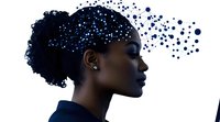 African American woman profile with digital particles dispersing from head representing artificial intelligence and data processing concepts.
