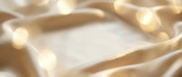 Luxurious champagne silk fabric with soft bokeh lights creates an elegant, flowing background suitable for premium product displays, wedding designs, and luxury branding projects.