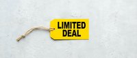 Yellow price tag with LIMITED DEAL text on light concrete background, retail sale promotion concept for marketing and advertising campaigns.