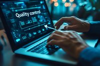 Professional working on laptop with quality control dashboard interface in dark office environment with blue ambient lighting and bokeh effects in background.