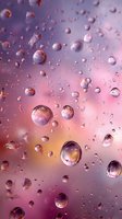 Water droplets on glass surface with pink and purple gradient background creating dreamy bokeh effect for cosmetic or wellness industry.