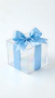Transparent acrylic gift box with blue satin ribbon bow isolated on white background for holiday celebrations and special occasions.