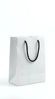 White paper shopping bag with black handles isolated on white background for retail and commercial use.