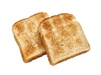 Two slices of golden-brown toasted bread isolated on white background, ready for breakfast, lunch, or bakery design projects.