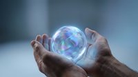 Hands holding glowing holographic sphere with rainbow reflections for futuristic technology and innovation concepts.