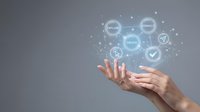Digital marketing strategy with hand gestures displaying connected icons for analytics, content, and engagement on gray background.