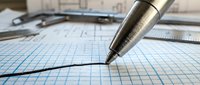 Precision pen drawing on graph paper with architectural blueprints and tools in background, suitable for engineering, design, and technical planning projects.