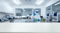 Scientist in protective suit conducting research in modern laboratory with test tubes and equipment for pharmaceutical development and analysis.