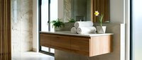 Modern bathroom interior with floating wooden vanity, marble walls, and minimalist design elements for contemporary home decor and renovation projects.