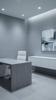Modern minimalist office interior with gray concrete desk, white leather chair and floating cabinet for contemporary workspace design.