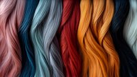 Colorful hair extensions in vibrant shades of pink, blue, red, orange and black arranged in wavy strands for beauty salon and hairstyling concepts.