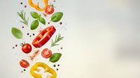 Fresh vegetables and herbs falling with tomatoes, bell peppers, basil leaves and spices on light background for healthy cooking and culinary design.