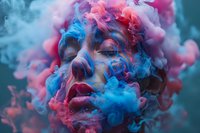 Artistic portrait of a woman's face enveloped in swirling pink and blue smoke creating a dreamy, ethereal atmosphere with vibrant makeup and closed eyes, suitable for creative projects.