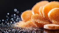 Fresh juicy mandarin or tangerine slices with water drops and sugar crystals on dark background, macro food photography with bokeh light effects.