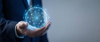 Businessman holding glowing digital network sphere with connected nodes representing global connectivity, technology innovation and data communication solutions.