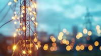 Illuminated telecommunication tower with glowing bokeh lights against twilight sky, creating atmospheric urban nightscape. Modern connectivity concept.