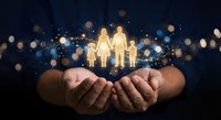 Cupped hands holding glowing family silhouettes with sparkling lights and bokeh effects against dark background for insurance and protection concepts.