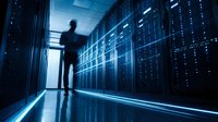 IT professional silhouette walking through modern data center server room with blue lighting and network infrastructure for technology concepts.